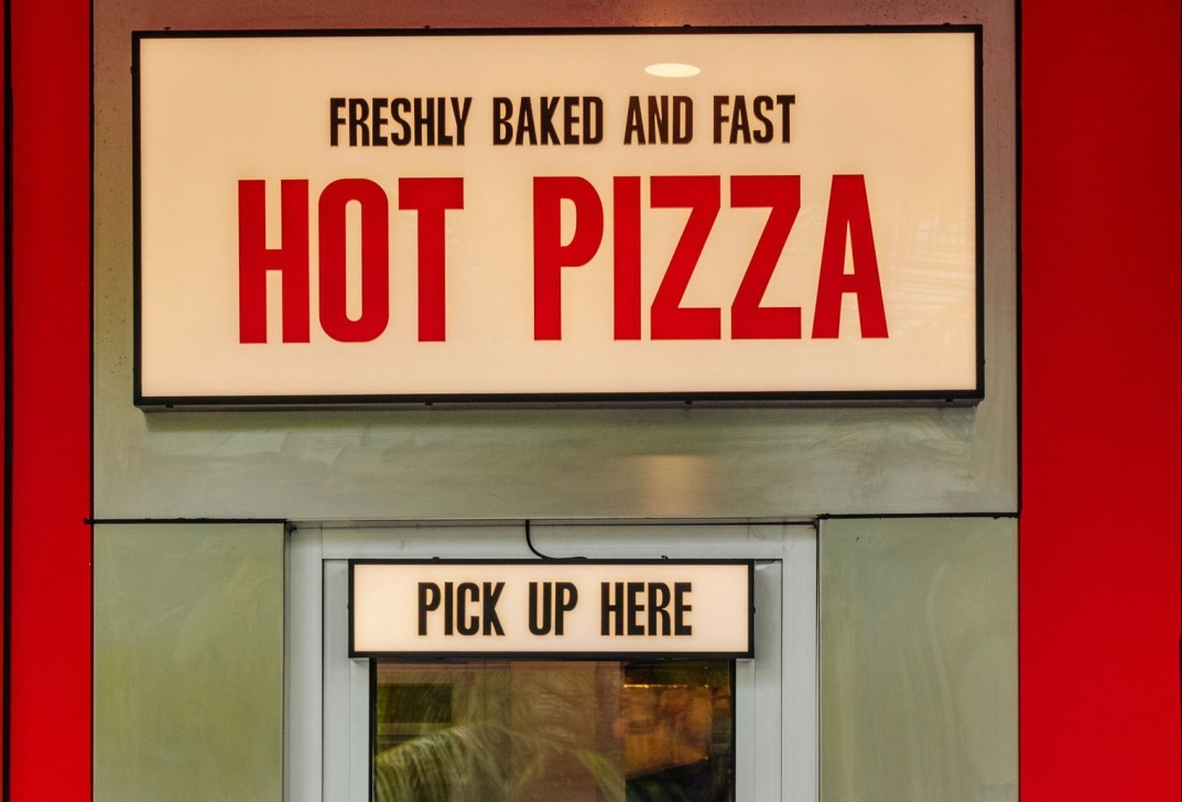 Customer at Doughboys Bali hot pizza pickup window