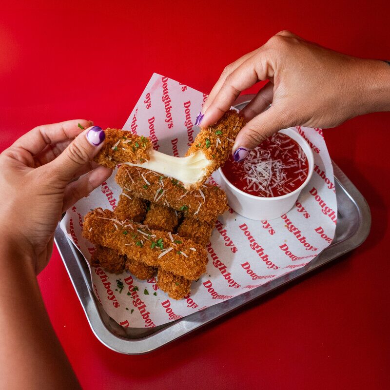 Crispy mozzarella sticks with marinara sauce from Doughboys