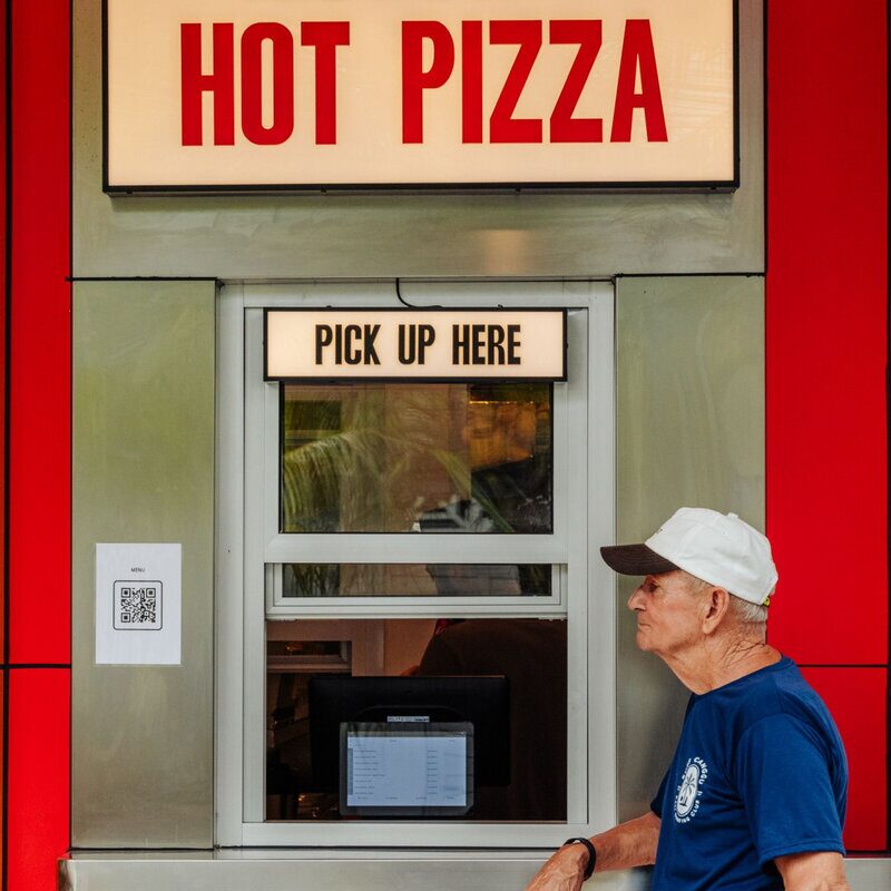 Customer at Doughboys hot pizza pickup window in Bali