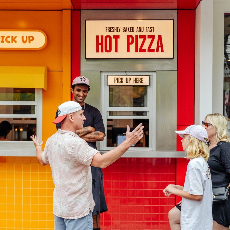 Happy customers at Doughboys hot pizza pickup window
