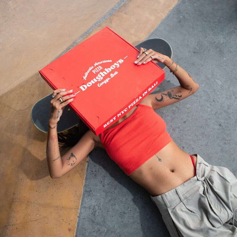 Doughboys pizza box with skateboard lifestyle shot in Canggu Bali