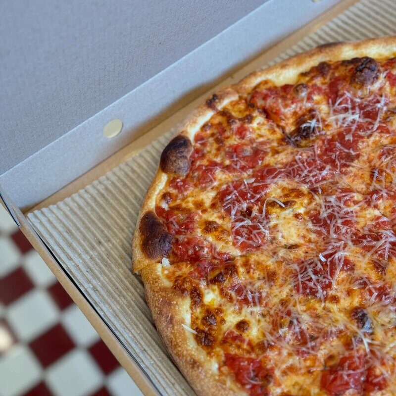 Delicious pizza slice on serving board at Doughboys Bali