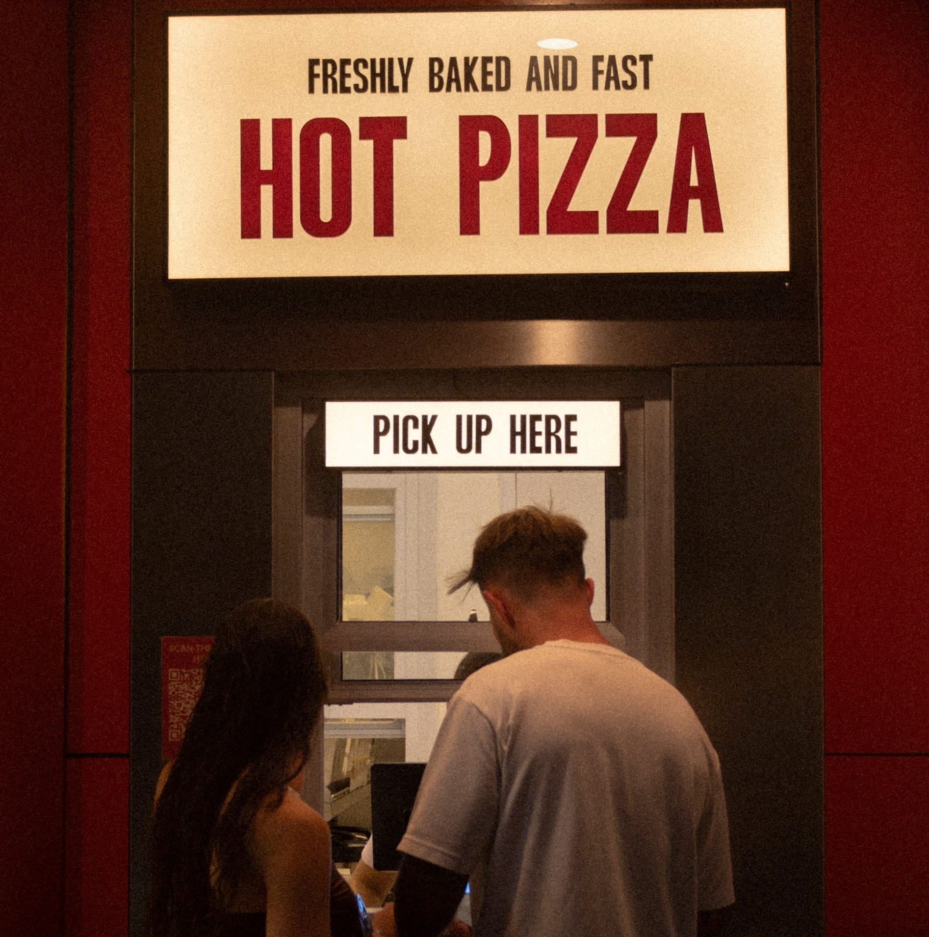 Happy customers at Doughboys hot pizza pickup window